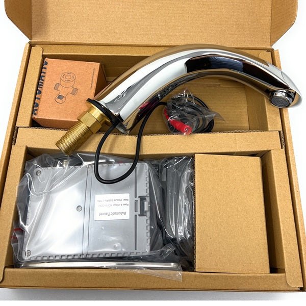 Automatic faucet kit packaged in a cardboard box, displaying the chrome spout, electronic control unit, and accessories.