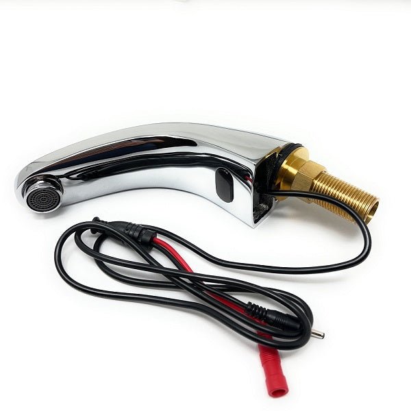 Close-up of a chrome automatic faucet spout showing brass connector and black-and-red wiring.