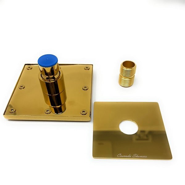 Disassembled gold-plated shower wall mount showing the base plate, threaded connector, and decorative cover plate laid out.