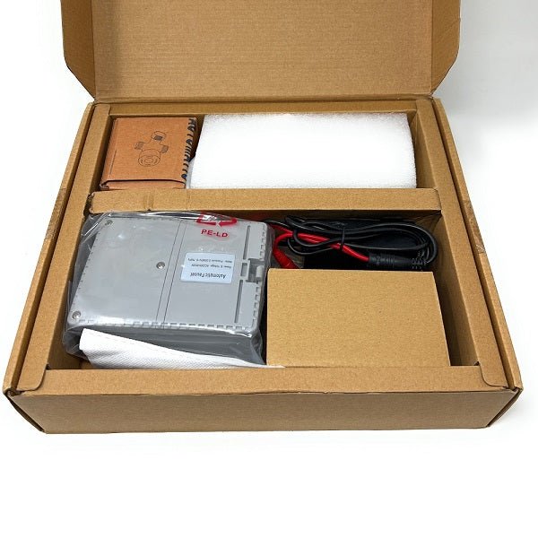 Open cardboard box containing electronic equipment and accessories of AquaSense sensor faucet